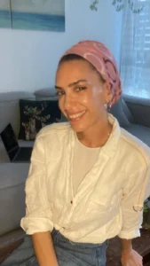 איילה זוהר מצוות מרכז חיוך יושבת ומחייכת